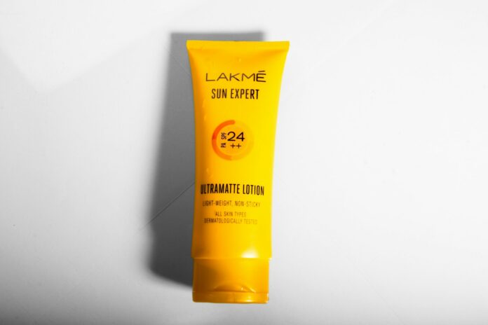 Photo by Lal MAHAMMAD a tube of sunscreen on a white surface