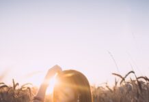 필라테스로 허리 통증 예방하기, 집에서도 가능한 동작들 woman sitting on grass field during sunset