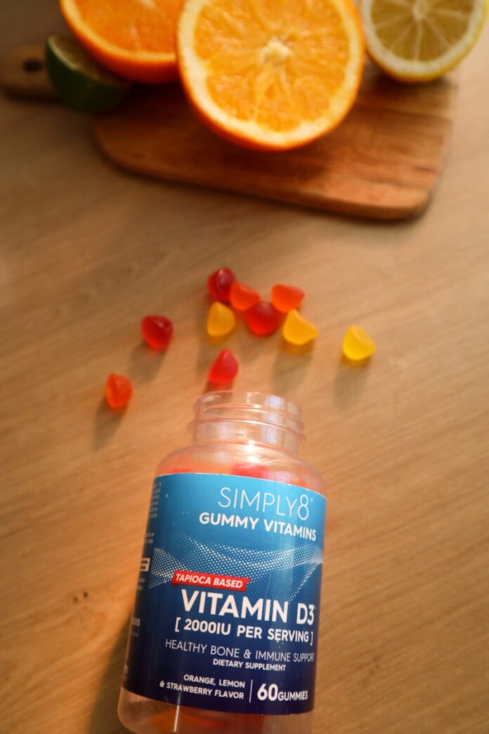 Photo by Maria Kozyr a bottle of gummy vitamins sitting on top of a wooden table